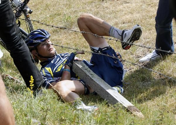 Johnny Hoogerland extracts himself from a barbed wire fence following a frightening crash caused by a French television car.