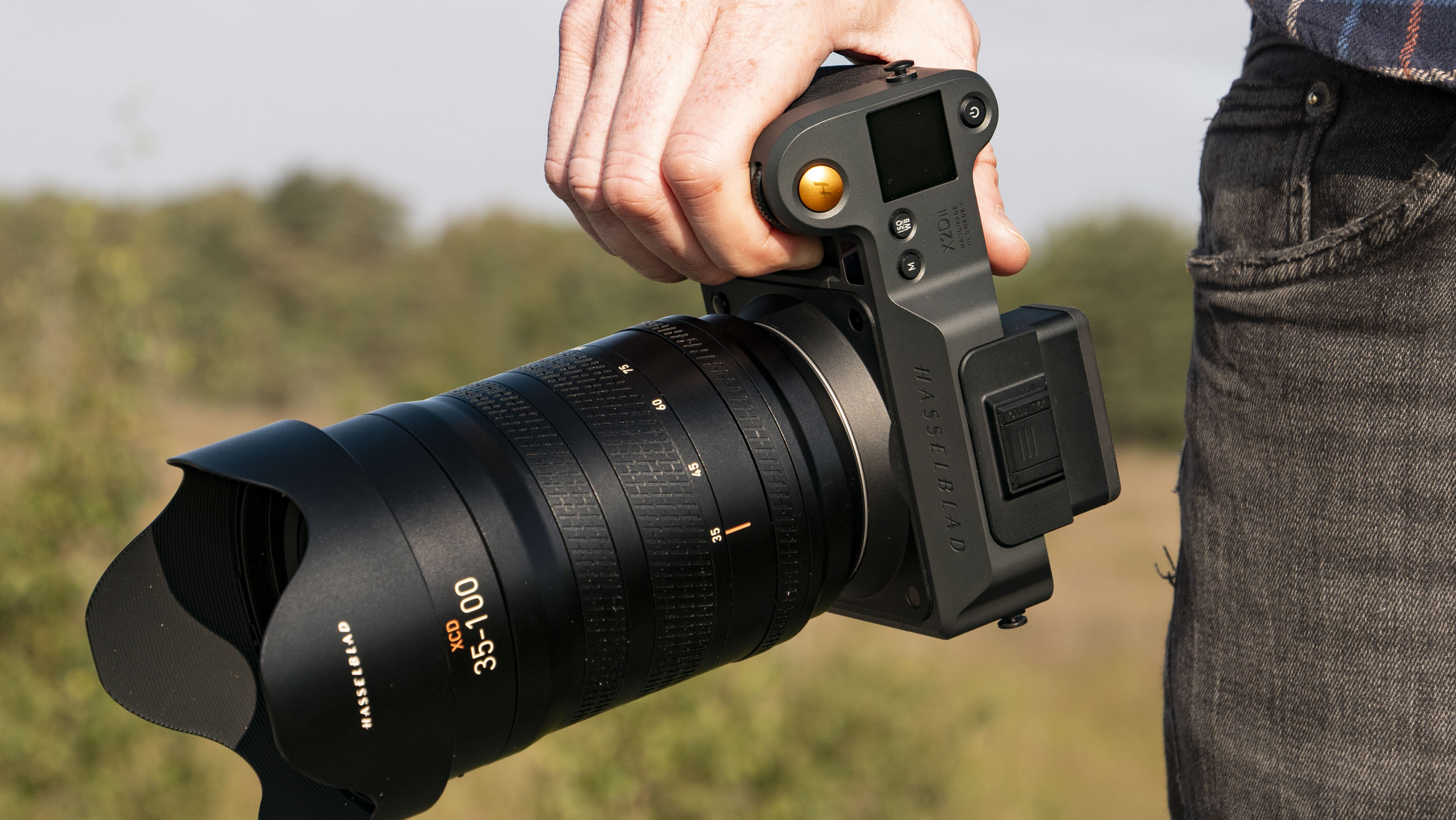 Hasselblad X2D II 100C camera in the hand, outdoors at first light
