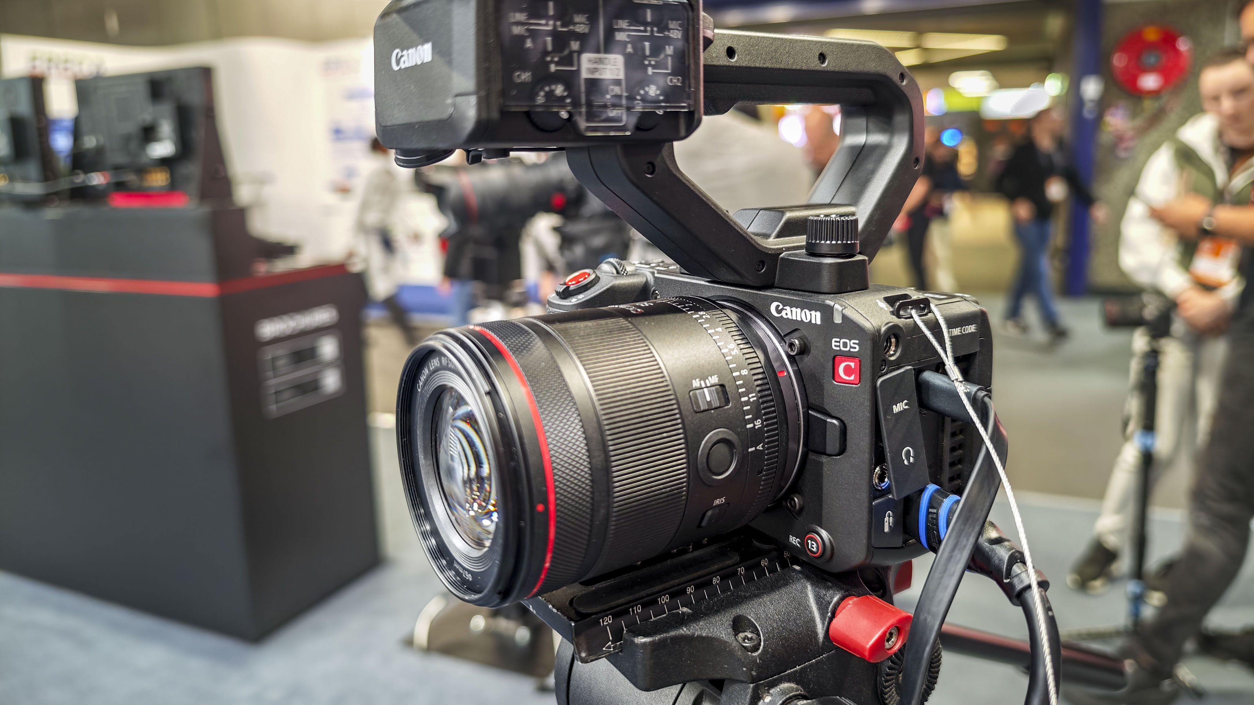 IBC 2025 show – Canon EOS C50 on a tripod with top handle attached and multiple extenral devices connected