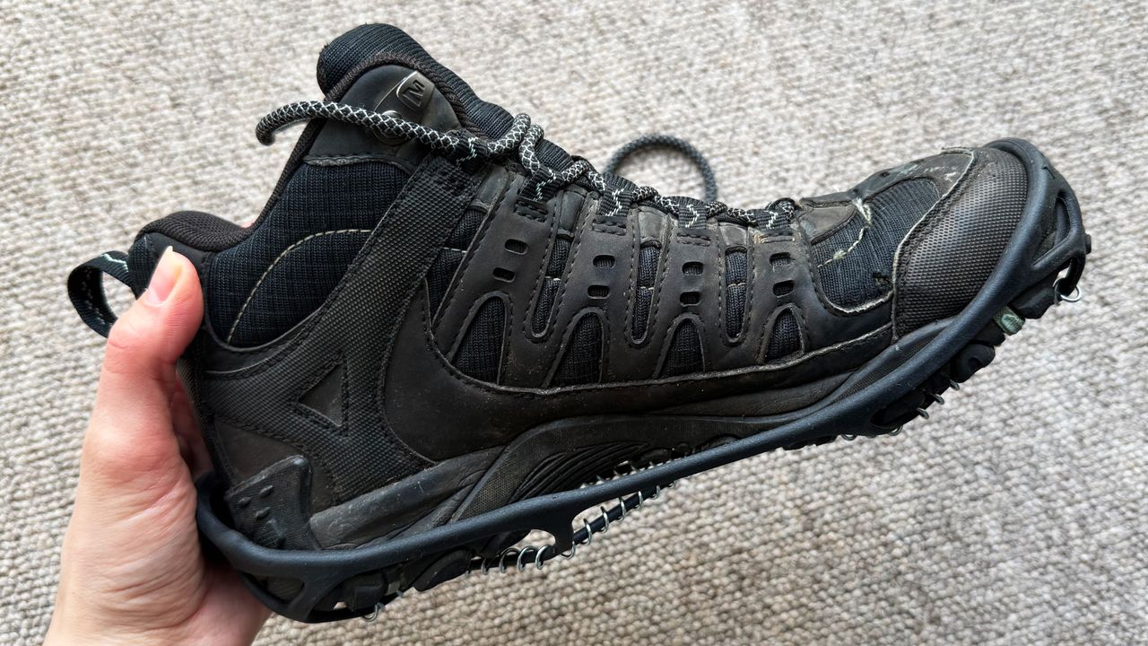 the merrell sport 3 hiking boots with yaktrax photographed inside, the sole, side, and top