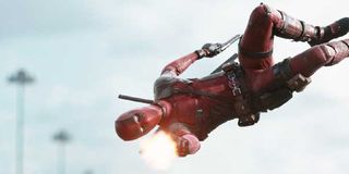 Deadpool leaps through the air firing his gun