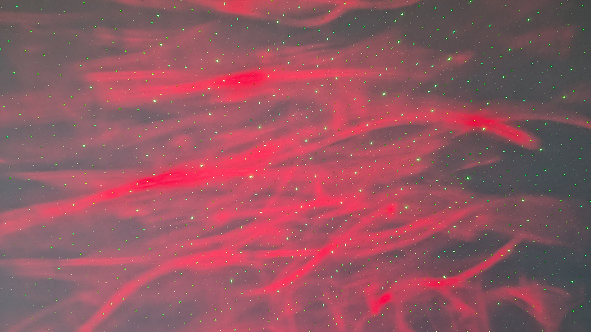 YgiTK Northern Galaxy Lights Projector during Review, on a wooden table against a dark coloured wall