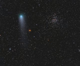 Comet 21P/Giacobini-Zinner passes by Messier 37 (also known as NGC 2099), an open star cluster in the modern constellation of Auriga, in this image captured by astrophotographer Alex Babiuc on Sept. 11, 2018.