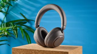the anker soundcore space 2 pro headphones in mauve gray photographed against a blue tom's guide background