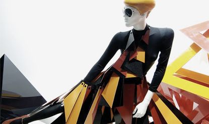 Mannequin wearing a black, orange and yellow outfit