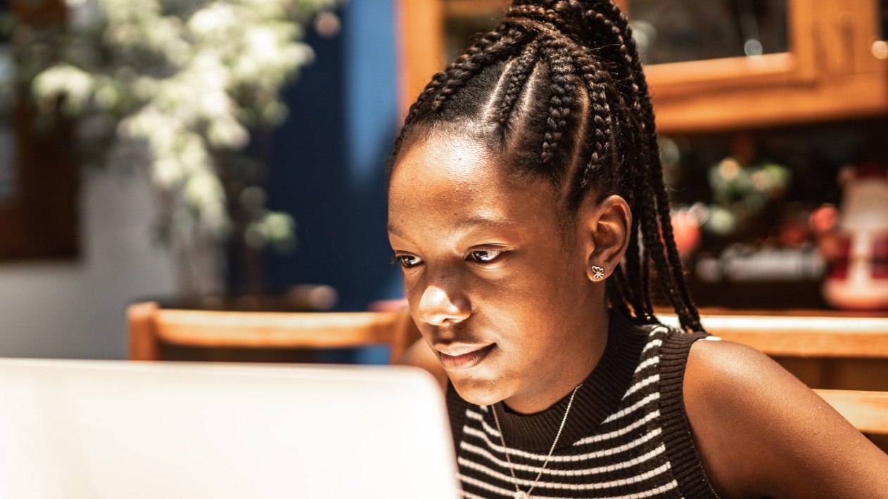 A young woman working on a computer.