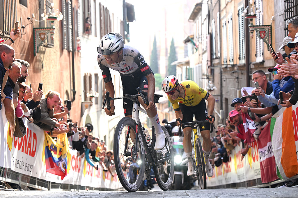 Wout van Aert follows Isaac del Toro up the climb into Siena on stage 9 of the Giro d'Italia