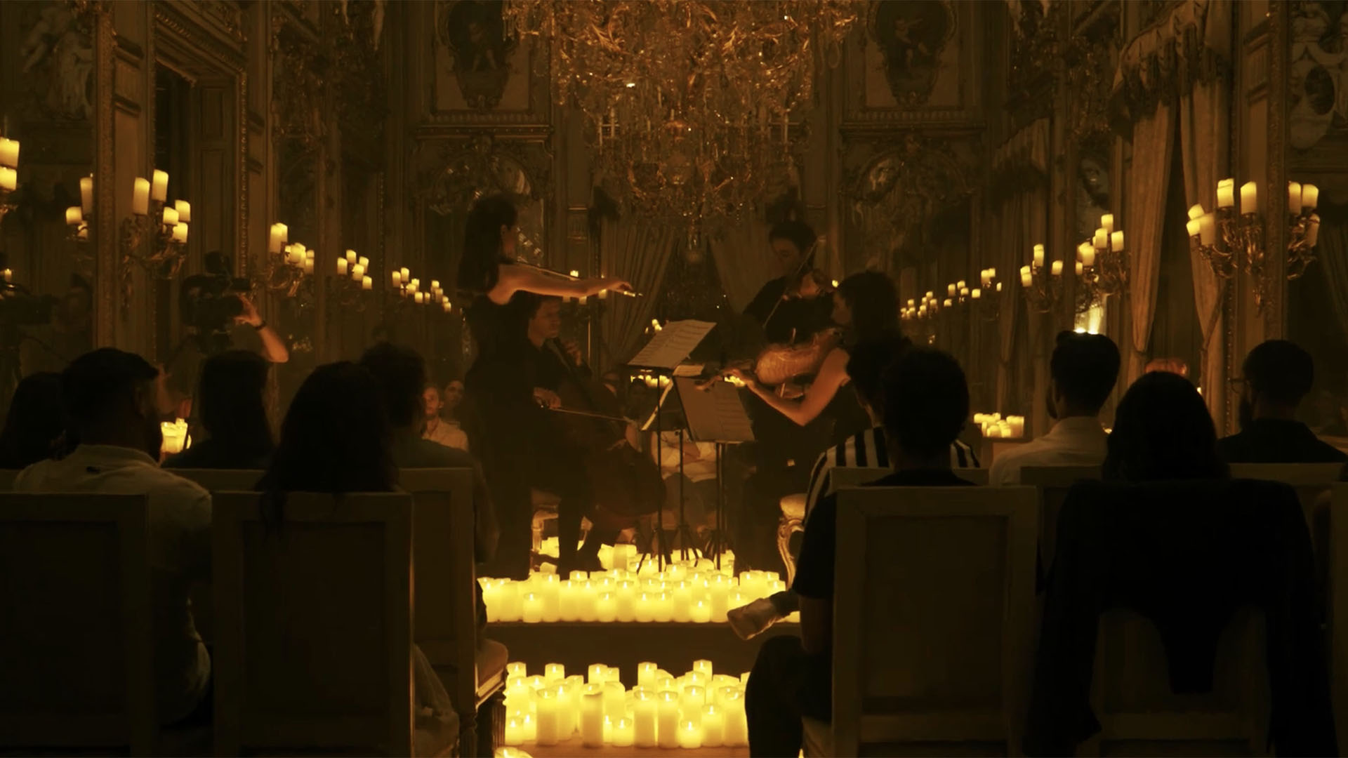 A photo of a string quartet playing in a concert hall. 