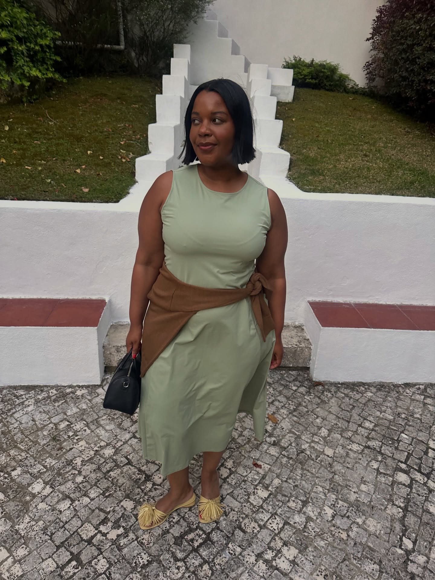 styleidealist wears a green midi dress and raffia sandals