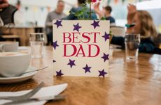 A Father's Day card with the words 'Best Dad' in red surrounded by blue stars