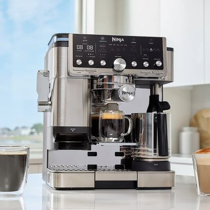 Ninja's new Pro series coffee machine on marble kitchen worktop surrounded by coffee drinks 