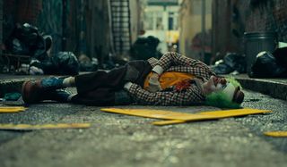 Joker Arthur lies in the street, after being beaten