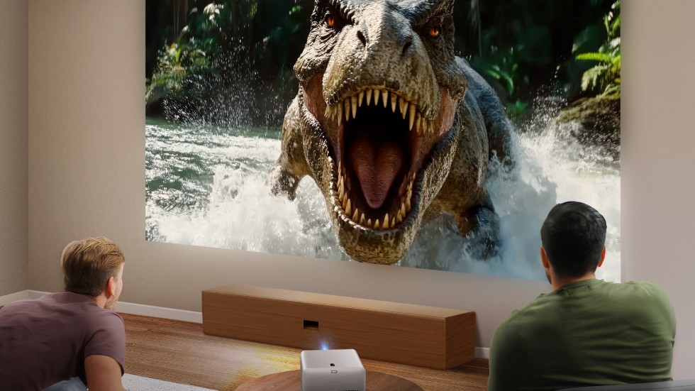 benQ TK705i projector showing an image of a roaring dinosaur.
