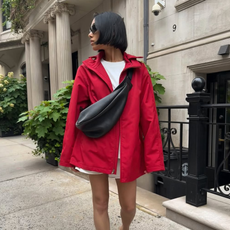 Shay in June wearing a red windbreaker jacket