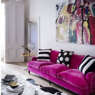 living area with pink sofa and wooden floor