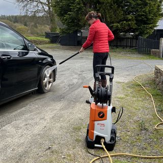 cleaning the car with a pressure washer
