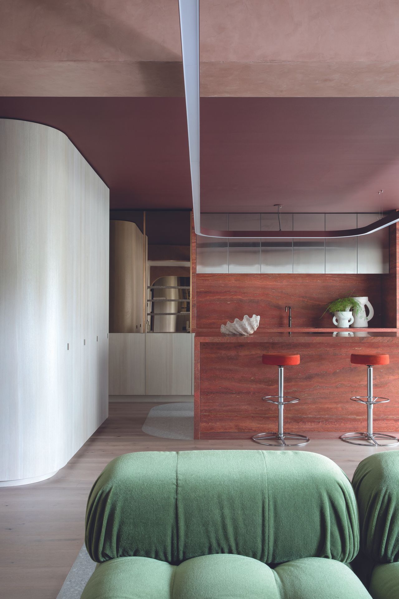 The mauve and Earthy toned kitchen with a green sofa
