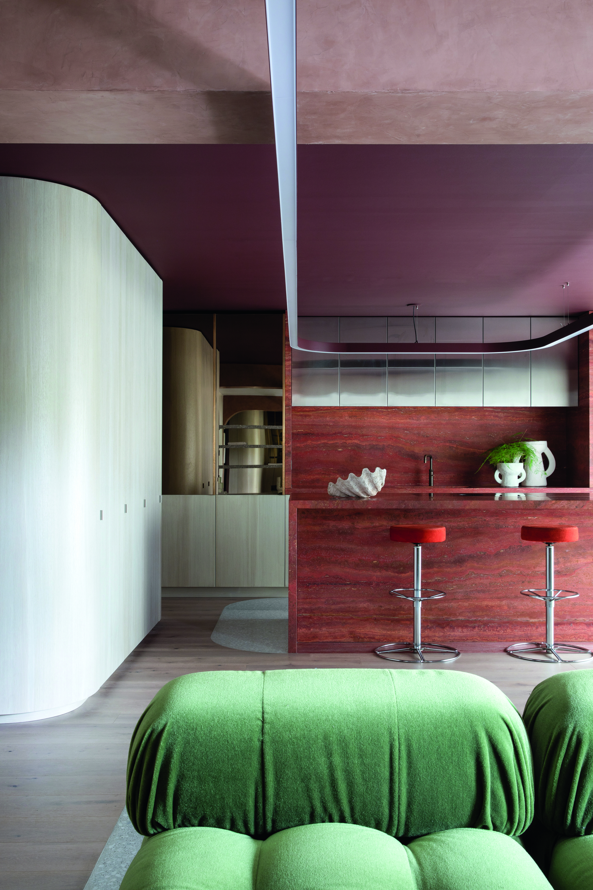 The mauve and Earthy toned kitchen with a green sofa 