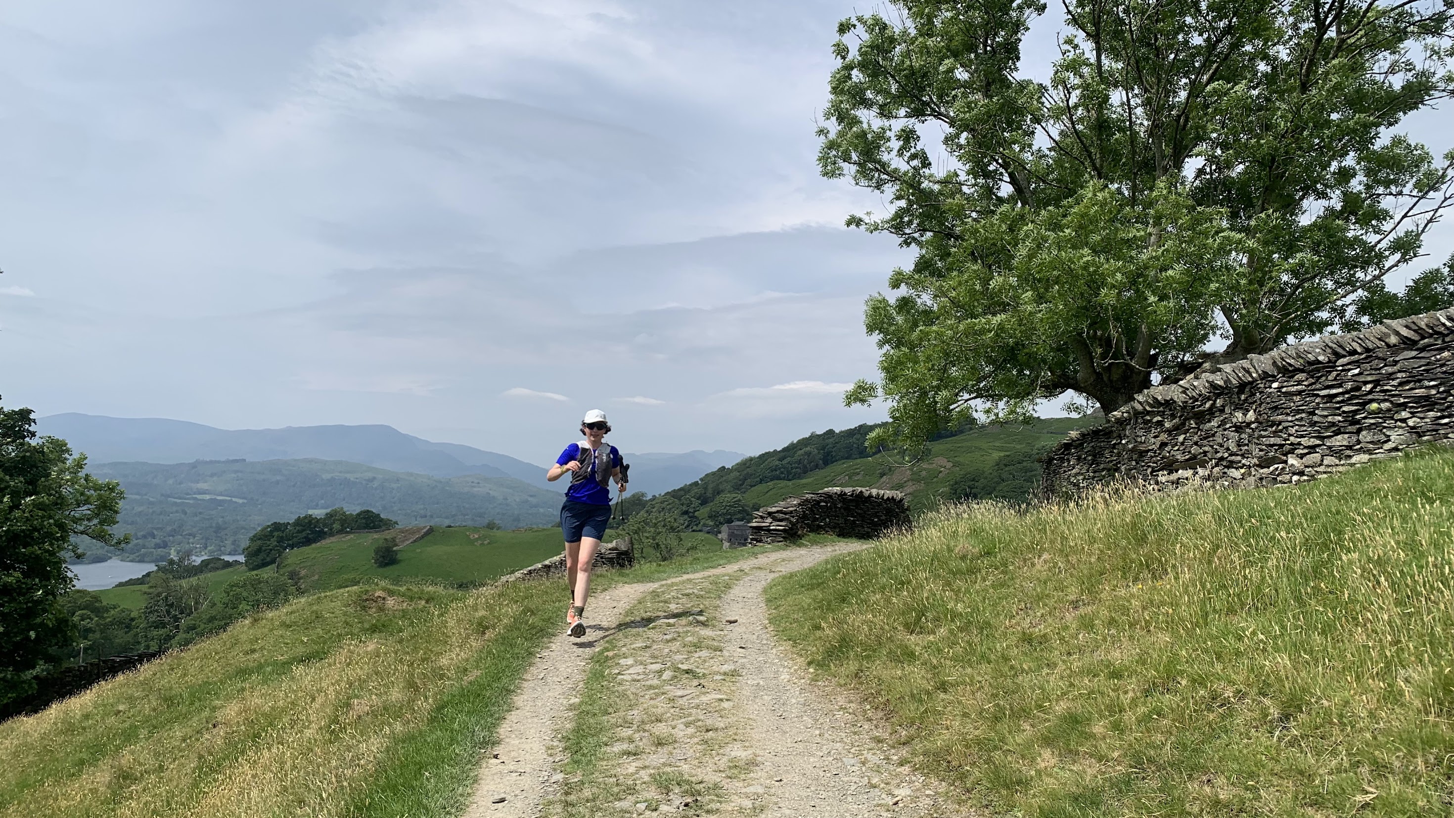 A woman running on a trail in the Lake District