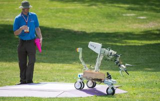 A robot built by the team Formicarum rolls off its starting platform during a level one rerun at NASA's 2015 Sample Return Robot Challenge on Friday, June 12, at the Worcester Polytechnic Institute (WPI) in Worcester, Mass. Sixteen teams are competing for