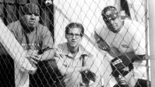 Suicidal Tendencies behind a chain fence in 1990
