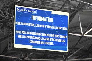 A photograph taken at Stade Velodrome in Marseille, southern France on October 29, 2023, shows an information board announcing supporters that the Ligue 1 encounter between Marseille and Lyon was postponed after the Lyon's travelling team bus, with one window completely broken and another damaged, was attacked with stones as it entered the Stade Velodrome ahead of the French L1 football match between Olympique Marseille (OM) and Olympique Lyonnais (OL). Lyon head coach Fabio Grosso and his assistant were injured during the attack. (Photo by CHRISTOPHE SIMON / AFP) (Photo by CHRISTOPHE SIMON/AFP via Getty Images