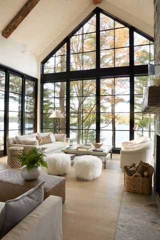 a lake house living room with large windows