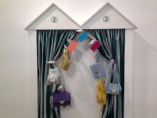 A beach hut display of designer spring handbags in fashionable colours