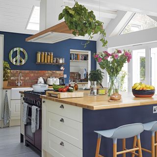 kitchen area with wooden worktop and flower jar with drawers