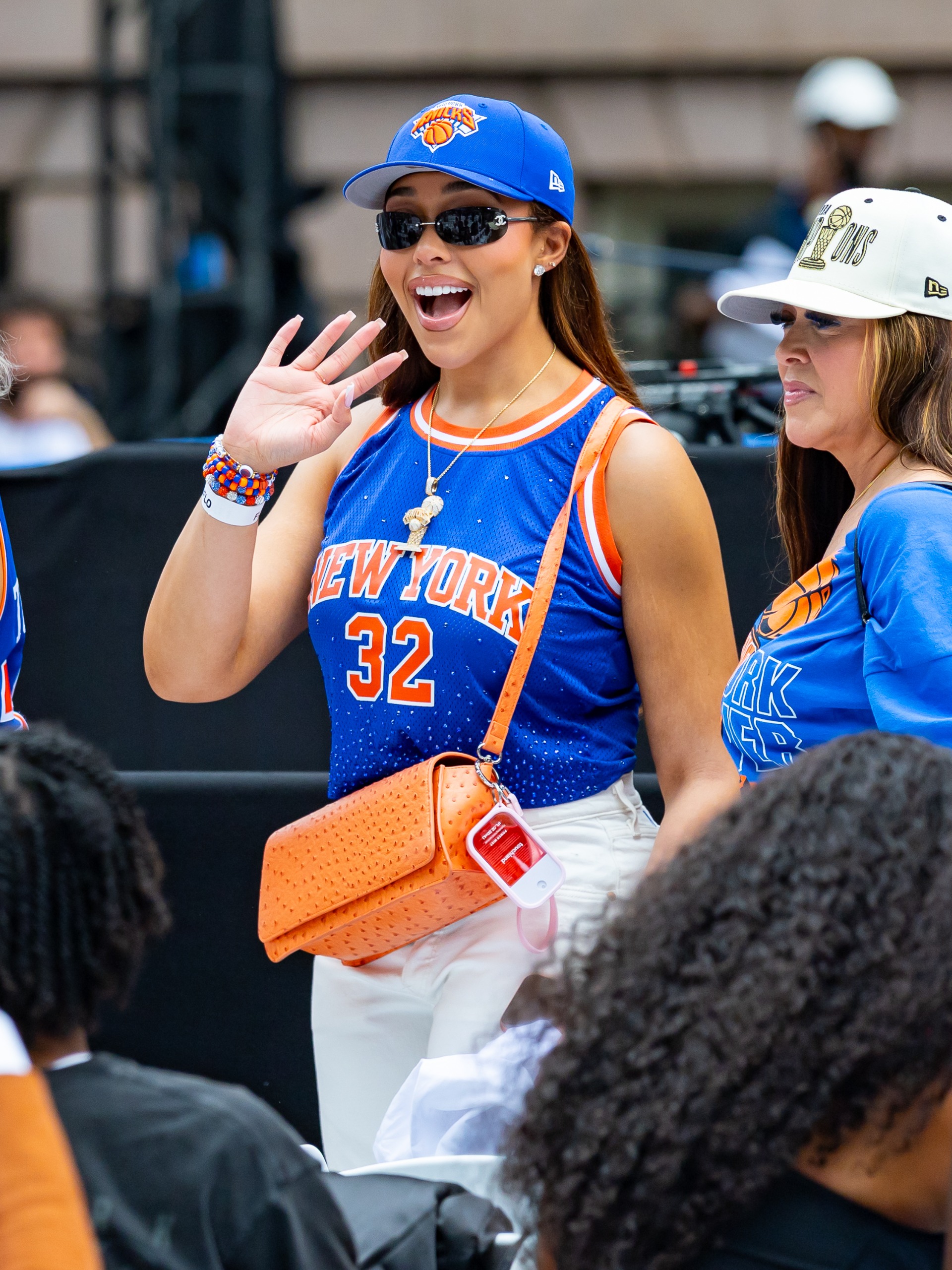 Angel Reese arrived at Game 5 of the WNBA Finals in a Protect Black Women T-shirt and Jordyn Woods's &amp;quot;lucky&amp;quot; orange New York Knicks bag