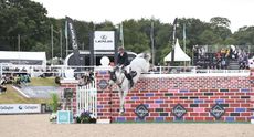 Guy Williams and Mr Blue Sky UK clear the puissance wall at Bolesworth