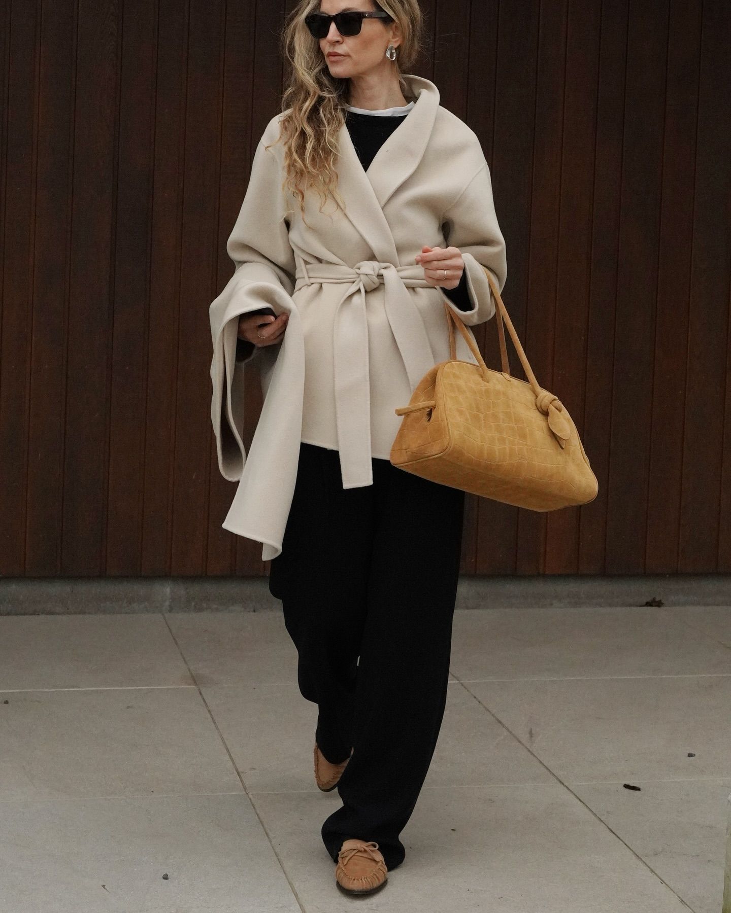 Influencer wears moccasin shoes.
