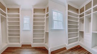 White built-in shelving compartments in a walk-in wardrobe