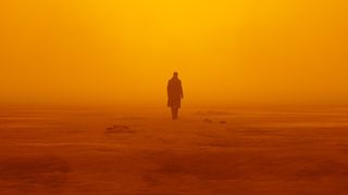 Ryan Gosling walking alone into a hazy orange background in Blade Runner 2049