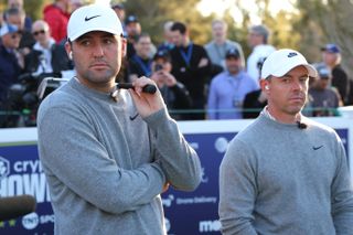 Scottie Scheffler and Rory McIlroy wait on the first tee