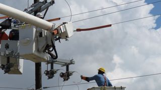 People working on electrical equipment