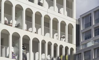 The architects' clever facade articulation creates a welcome lightness and verticality for the relatively large housing block