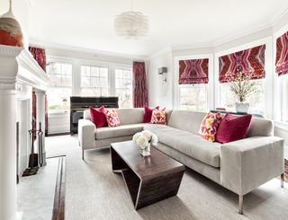 a living room with red curtains