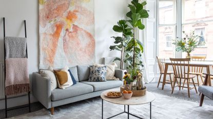 living room with blue sofa and dining table