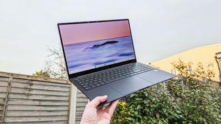 Samsung Galaxy Chromebook Plus held in hand holding up to sky