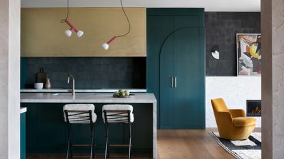 Colors that go with gold: Kitchen with forest green painted cupboard, forest green splashback and gold upper cabinets