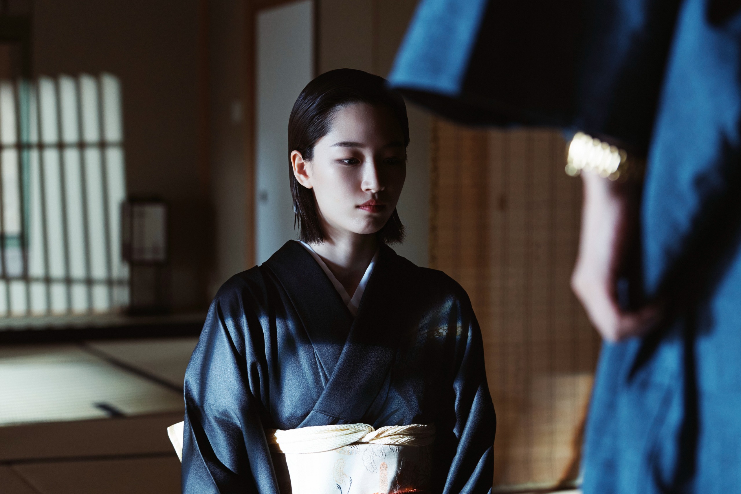 A woman wearing traditional Japanese clothing (Won Ji-an as Ikeda Yuji) kneels in a traditional Japanese room in front of an unseen person, in Hulu's 'Made in Korea.'