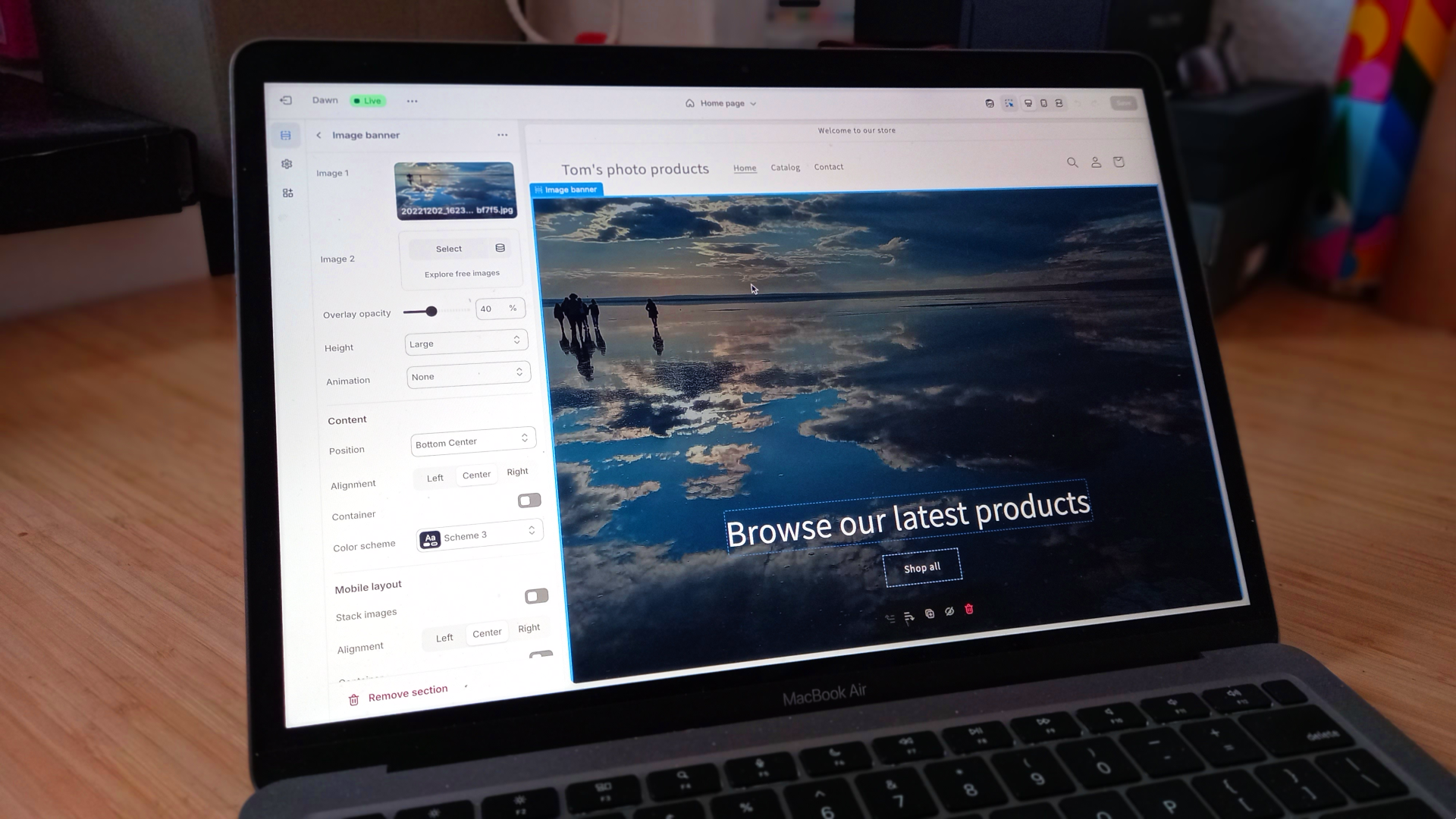 Laptop on desk showing Shopify interface