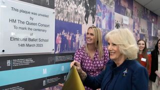 Camilla, Queen Consort unveils a plaque during a visit to Elmhurst Ballet School