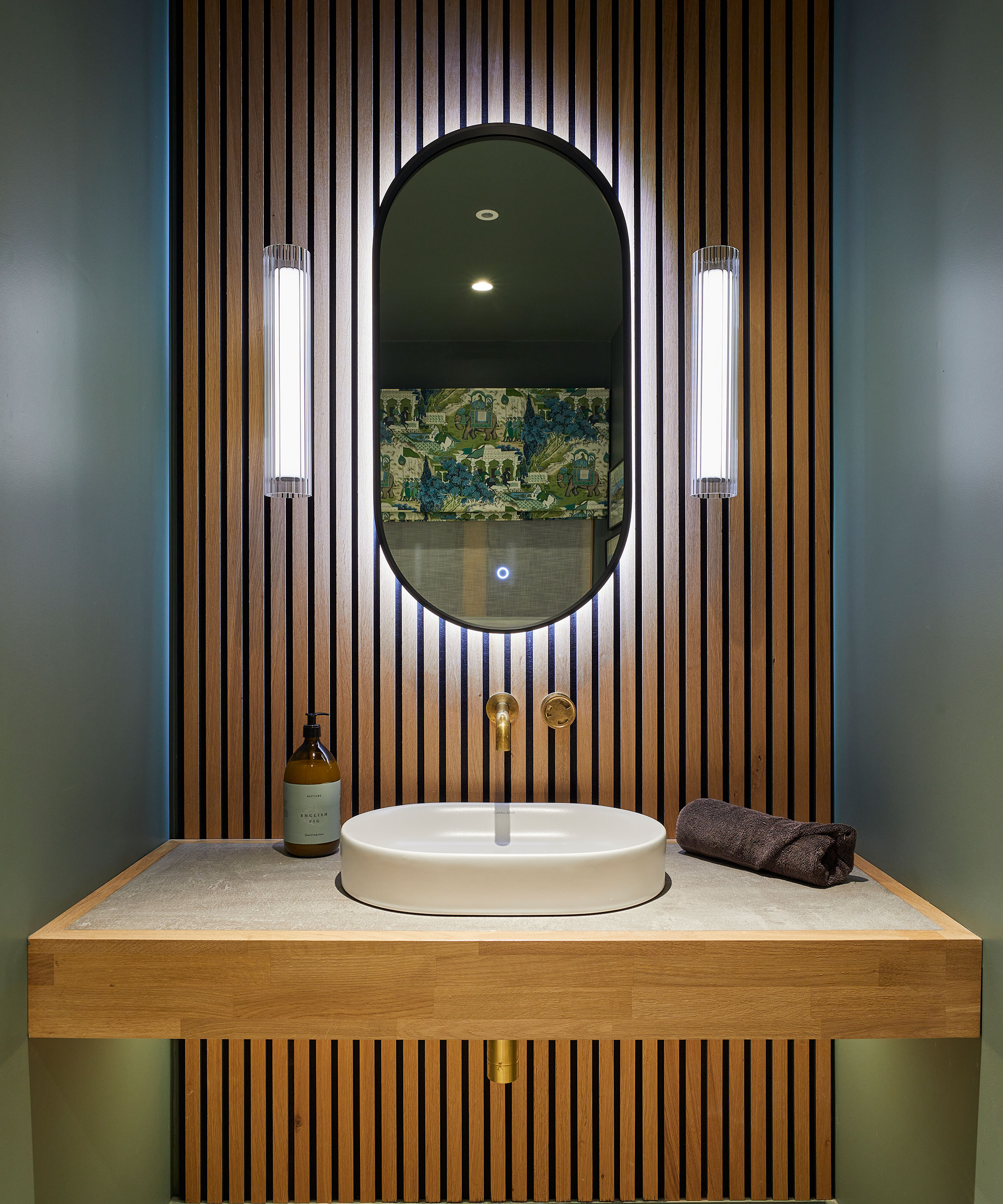 modern vanity unit with vertical modern timber cladding and mirror lighting