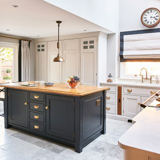 kitchen with clock and tap