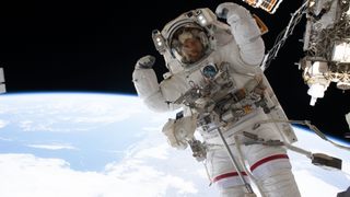 NASA astronaut Chris Williams flexes his muscles while on a spacewalk.