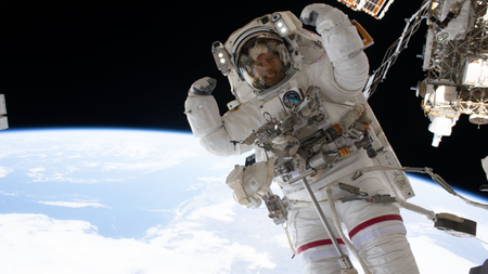 NASA astronaut Chris Williams flexes his muscles while on a spacewalk. 
