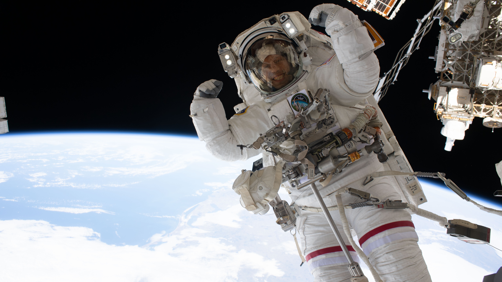 NASA astronaut Chris Williams flexes his muscles while on a spacewalk. 