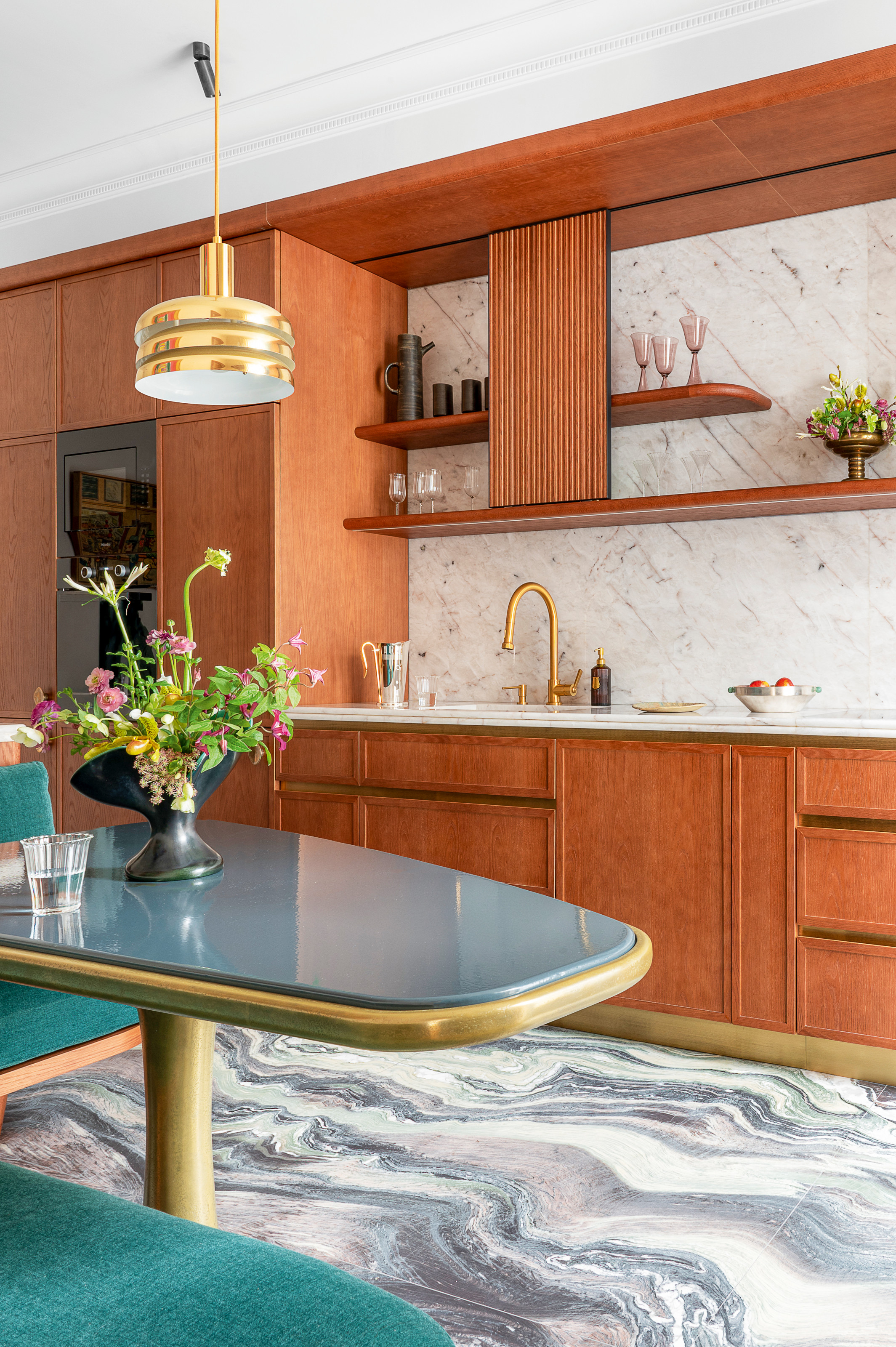 Rich wood kitchen with breakfast nook with turquoise banquet seating